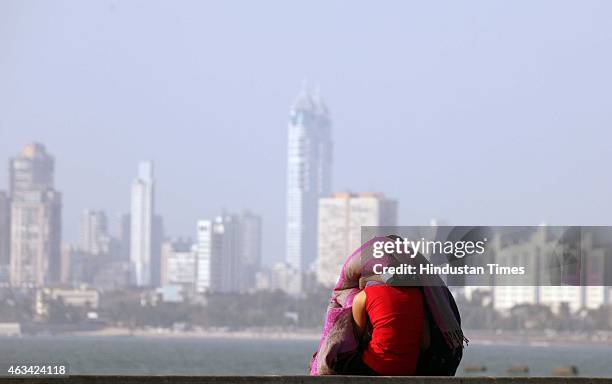 Couple sits on a promenade as they enjoy Valentine's Day at Marine Drive, on February 14, 2015 in Mumbai, India. Valentine's Day, also known as Saint...