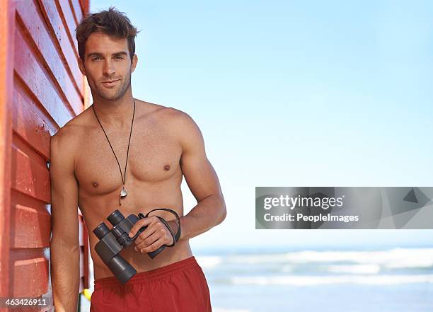 he's keeping an eye on you - hunky guy on beach stock pictures, royalty-free photos & images