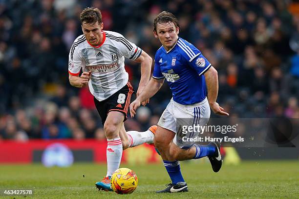 Jay Tabb of Ipswich Town is pursued by Fulham captain Scott Parker during the Sky Bet Championship match between Fulham and Ipswich Town at Craven...
