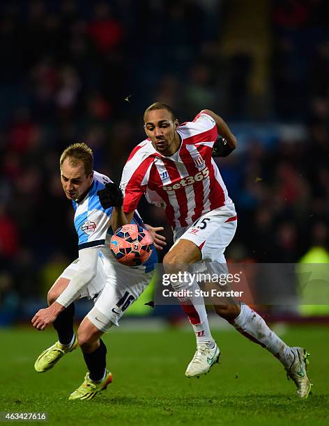 Stoke player Steven Nzonzi is challenged by Luke Varney of Blackburn during the FA Cup Fifth round match between Blackburn Rovers and Stoke City at...