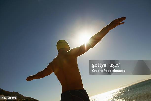 basking in the sun's warmth - muscle men at beach stock pictures, royalty-free photos & images