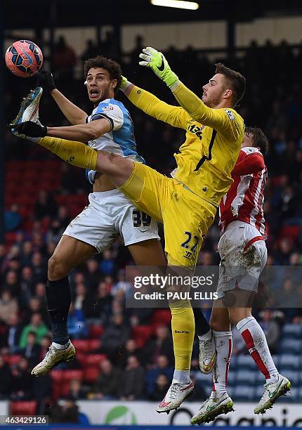 Blackburn's French-born Beninese striker Rudy Gestede vies with Stoke City's English goalkeeper Jack Butland during the English FA Cup fifth round...