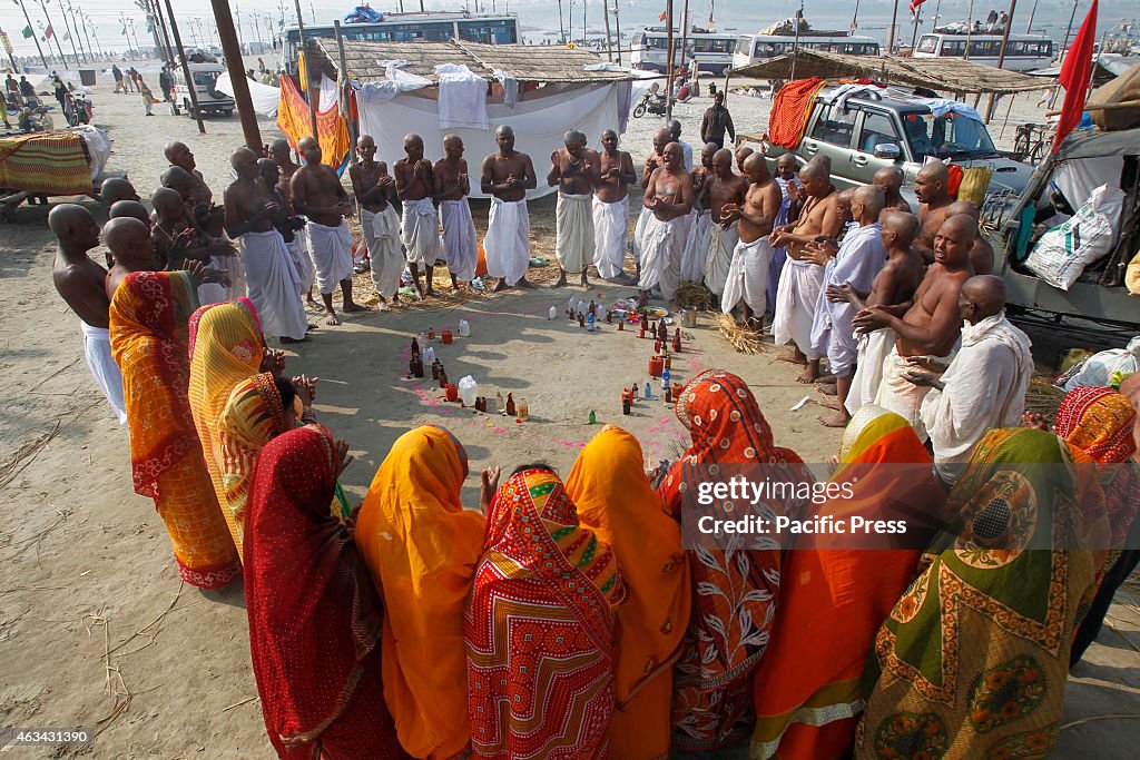 Hindu devotees offer prayers after taking holy dip in the...
