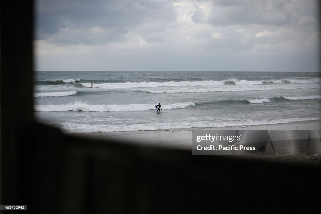 Palestinian surfers enjoy in the Mediterranean Sea of Gaza...