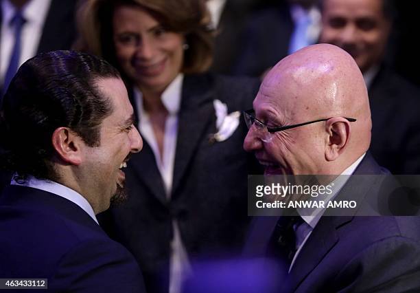 Former Lebanese prime minister Saad Hariri shares a laugh with Lebanese Prime Minister Tammam Salam as he attends a gathering to mark the tenth...