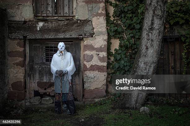 Man with his face covered with a mask know as 'Mascarita' poses for a picture as he joins a carnival festival on February 14, 2015 in Luzon, Spain....