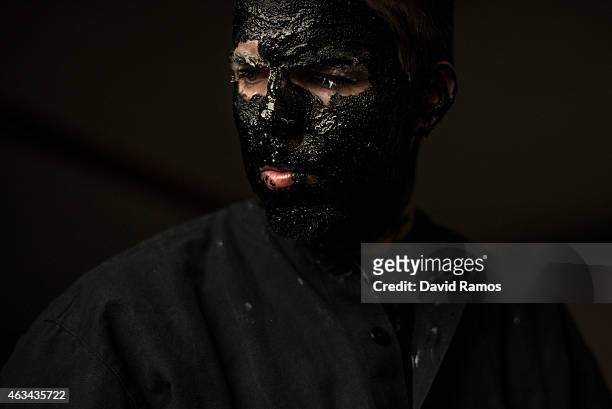 Man paints his face with oil and soot as he dresses up as a devil to join a carnival festival on February 14, 2015 in Luzon, Spain. Every year Luzon...