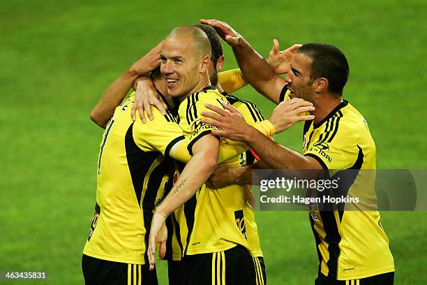 Jeremy Brockie of the Phoenix is congratulated on his goal by teammates Stein Huysegems and Manny Muscat during the round 15 A-League match between...