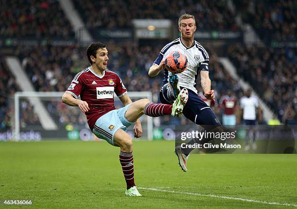 Stewart Downing of West Ham United and Chris Brunt of West Bromwich Albion battle for the ball during the FA Cup Fifth Round match between West...