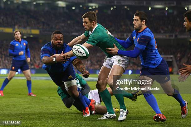 Mathieu Bastareaud of France feeds a pass as Tommy Bowe of Ireland closes in during the RBS Six Nations match between Ireland and France at the Aviva...