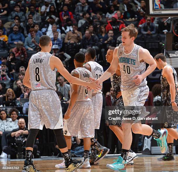 Zach LaVine of the Minnesota Timberwolves and Cody Zeller of the Charlotte Hornets shake hands during the 2015 NBA All-Star Rookie Rising Stars...