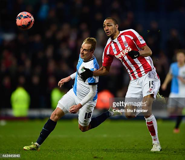 Stoke player Steven Nzonzi is challenged by Luke Varney of Blackburn during the FA Cup Fifth round match between Blackburn Rovers and Stoke City at...