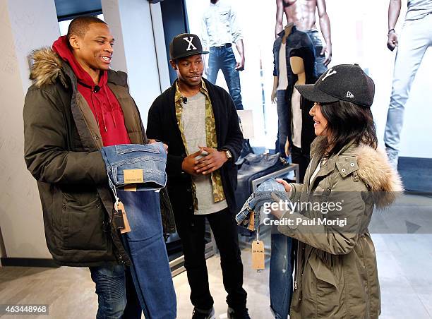 Player Russell Westbrook rewards a style review contestant with a new pair of True Religion jeans at the launch of his True Religion campaign at...