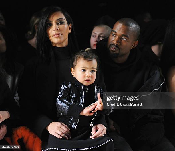 Kim Kardashian, North West and Kanye West attend the Alexander Wang Fashion Show during Mercedes-Benz Fashion Week Fall 2015 at Pier 94 on February...