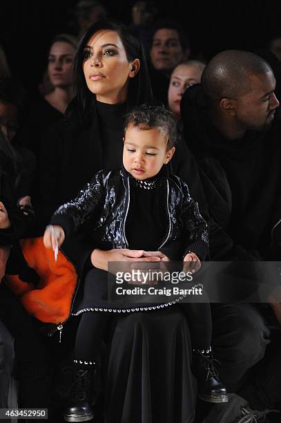 Kim Kardashian, North West and Kanye West attend the Alexander Wang Fashion Show during Mercedes-Benz Fashion Week Fall 2015 at Pier 94 on February...