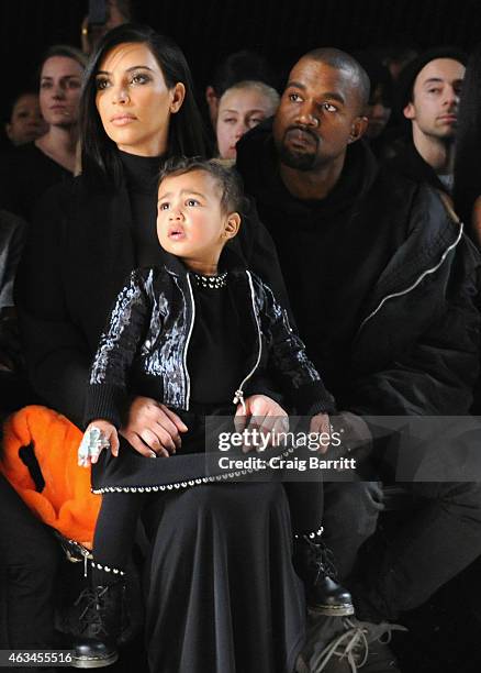 Kim Kardashian, North West and Kanye West attend the Alexander Wang Fashion Show during Mercedes-Benz Fashion Week Fall 2015 at Pier 94 on February...