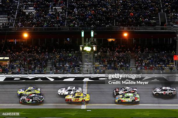 Paul Menard, driver of the Peak/Menard's Chevrolet, and Kasey Kahne, driver of the Great Clips Chevrolet, lead the field through the green flag to...