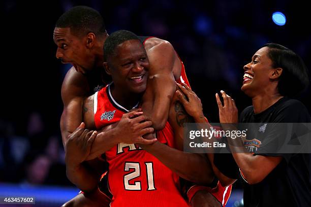 Chris Bosh of the Miami Heat and the Eastern Conference celebrates with NBA Legend Dominique Wilkins and Swin Cash of the New York Liberty after...