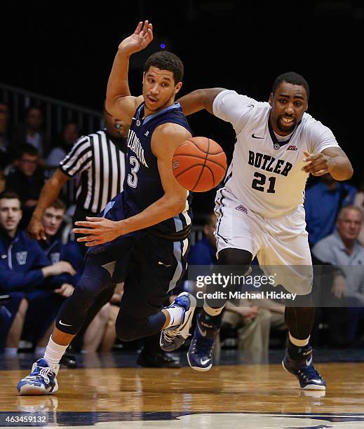 Josh Hart of the Villanova Wildcats and Roosevelt Jones of the Butler Bulldogs chase a loose ball at Hinkle Fieldhouse on February 14, 2015 in...