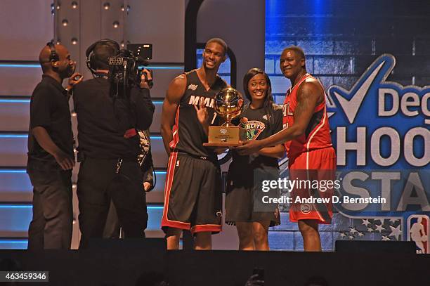 Chris Bosh, Dominique Wilkins and Swin Cash are presented with the trophy after the Degree Shooting Stars on State Farm All-Star Saturday Night as...