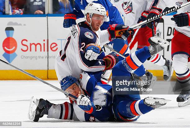 James Wisniewski of the Columbus Blue Jackets and Mikhail Grabovski of the New York Islanders collide at center ice at Nassau Veterans Memorial...