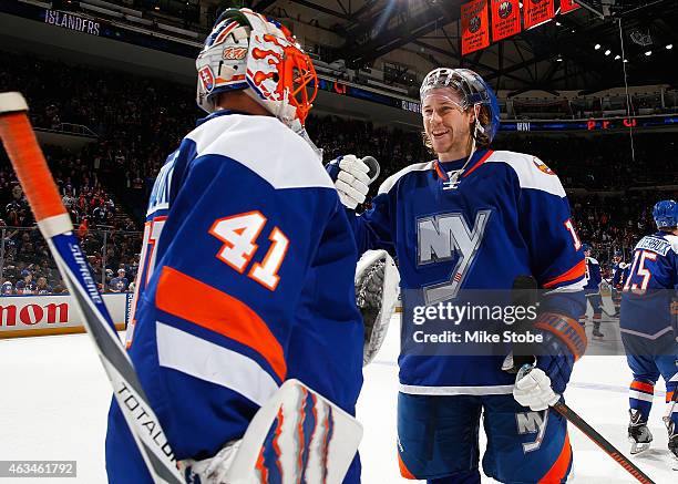 Jaroslav Halak of the New York Islanders is congratulated by teammate Matt Martin after defeating the Columbus Blue Jackets at Nassau Veterans...