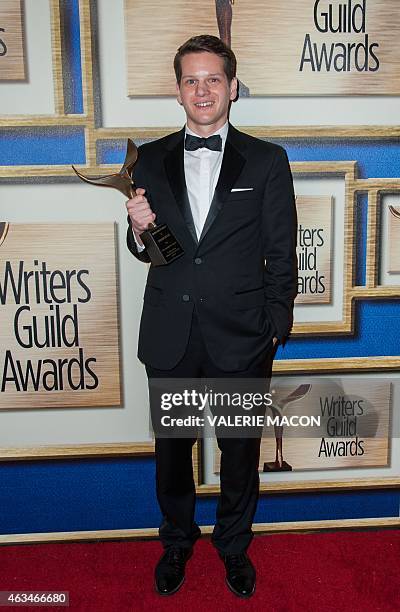 Writer Graham Moore poses in the press room at the 2015 Writers Guild Awards in Los Angeles on February 14, 2015. AFP PHOTO / VALERIE MACON