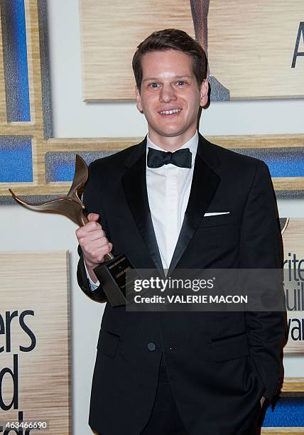 Writer Graham Moore poses in the press room at the 2015 Writers Guild Awards in Los Angeles on February 14, 2015. AFP PHOTO / VALERIE MACON