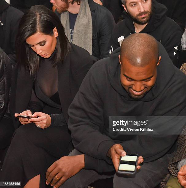 Kim Kardashian and Kanye West attend the Robert Geller show during Mercedes-Benz Fashion Week Fall 2015 at Pier 59 on February 14, 2015 in New York...