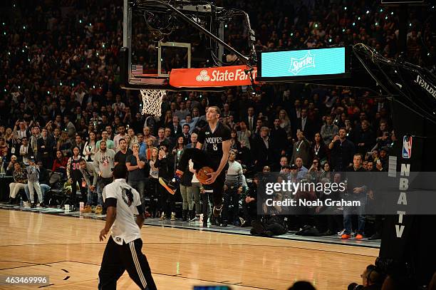 Zach LaVine of the Minnesota Timberwolves dunks with an assist from teammate Shabazz Muhammad during the Sprite Slam Dunk Contest on State Farm...