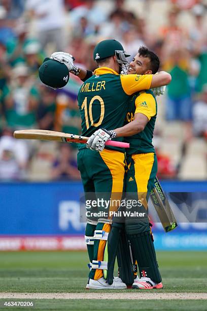 Duminy of South Africa celebrates his century with David Miller during the 2015 ICC Cricket World Cup match between South Africa and Zimbabwe at...