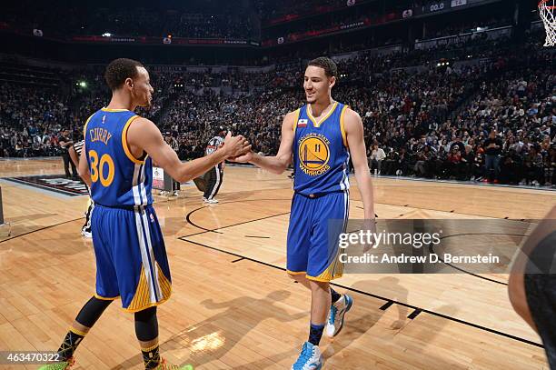 Klay Thompson and Stephen Curry of the Golden State Warriors shake hands during the Foot Locker Three Point Contest on State Farm All-Star Saturday...