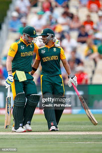 Duminy and David Miller of South Africa celebrate during the 2015 ICC Cricket World Cup match between South Africa and Zimbabwe at Seddon Park on...