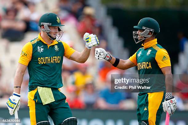 Duminy and David Miller of South Africa celebrate during the 2015 ICC Cricket World Cup match between South Africa and Zimbabwe at Seddon Park on...