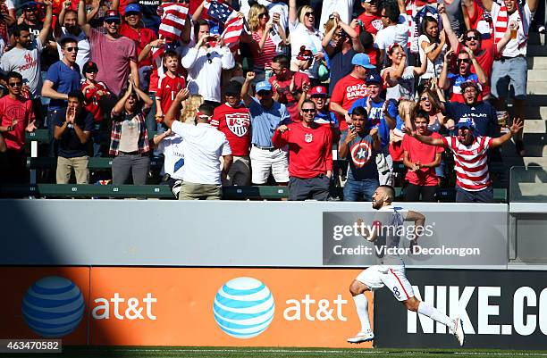 Clint Dempsey of the USA runs to the corner to celebrate after scoring a goal as fans cheer him on in the first half against Panama during their...