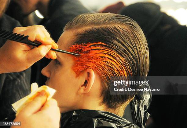 Model prepares backstage at the Robert Geller fashion show during Mercedes-Benz Fashion Week Fall 2015 at Pier 59 on February 14, 2015 in New York...