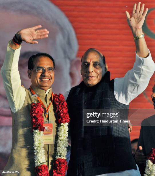President Rajnath Singh felecitates Madhya Pradesh Chief Minister Shivraj Singh Chauhan for his hatrick in assembly election at the BJP National...