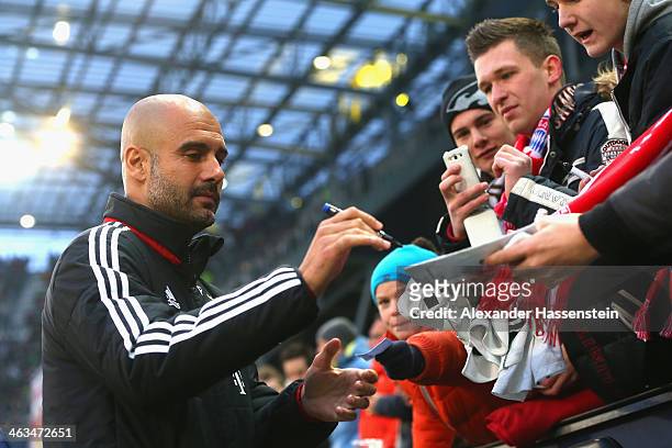 Josep Guardiola, head coach of Bayern Muenchen signs autographs prior to the friendly match between Red Bull Salzburg and FC Bayern Muenchen at Red...