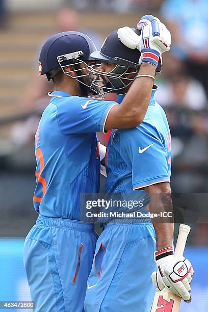 Virat Kohli of India bats hugs Shikhar Dhawan who made a half century during the 2015 ICC Cricket World Cup match between India and Pakistan at...