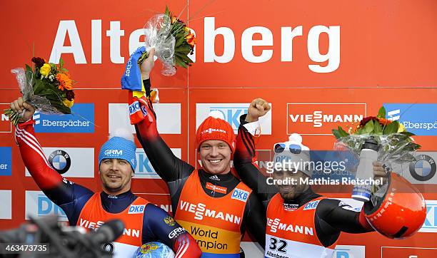 Albert Demchenko of Russia second placed, Felix Loch of Germany winner, and Andi Langenhan of Germany , third placed, jubilate during the flower...