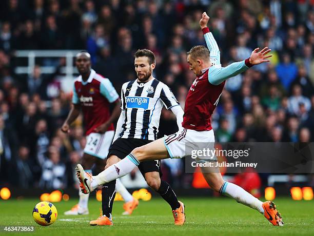 Yohan Cabaye of Newcastle United is challenged by Jack Collison of West Ham United during the Barclays Premier League match between West Ham United...