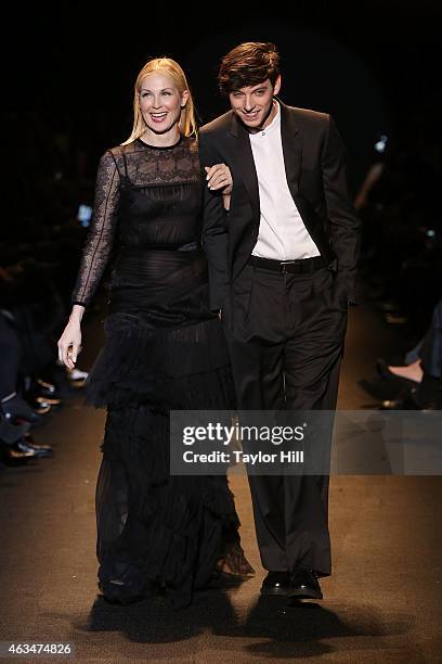 Actress Kelly Rutherford and model Trevor Feehan walk the runway during Naomi Campbell's Fashion For Relief 2015 fall fashion show at The Theater at...