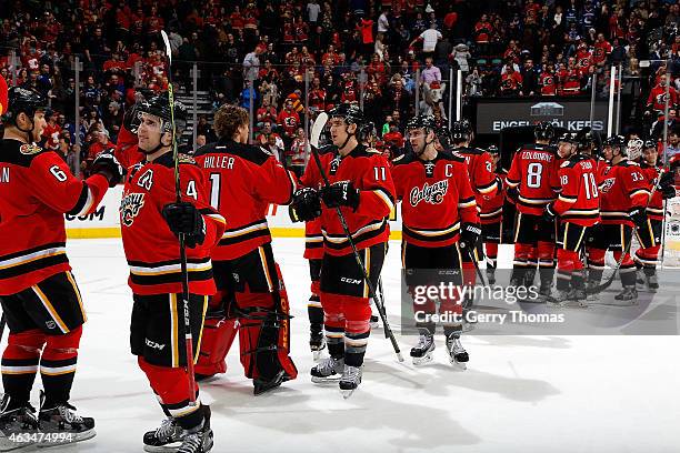 Members of the Calgary Flames celebrate a 3-2 win against the Vancouver Canucks at Scotiabank Saddledome on February 14, 2015 in Calgary, Alberta,...