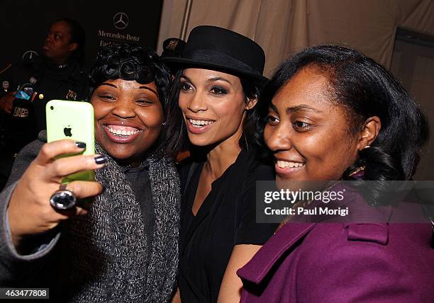 Rosario Dawson poses for a selfie with fans backstage at Lincoln Center for the Performing Arts during Mercedes-Benz Fashion Week Fall 2015 on...