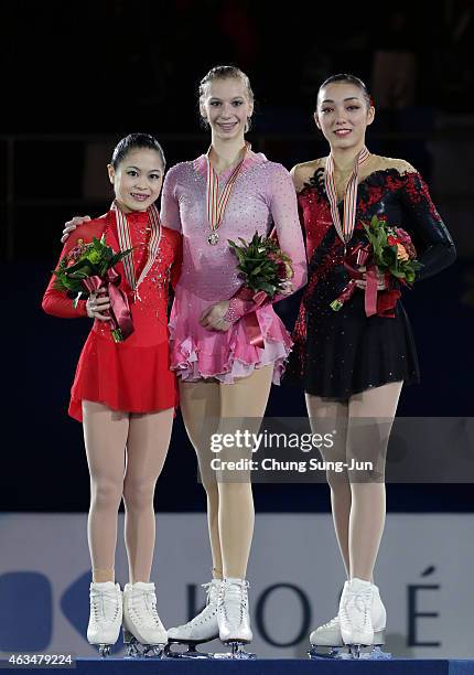 2nd place Satoko Miyahara of Japan, 1st place Polina Edmunds of USA and 3rd place Rika Hongo of Japan pose on the podium after the medals ceremony of...