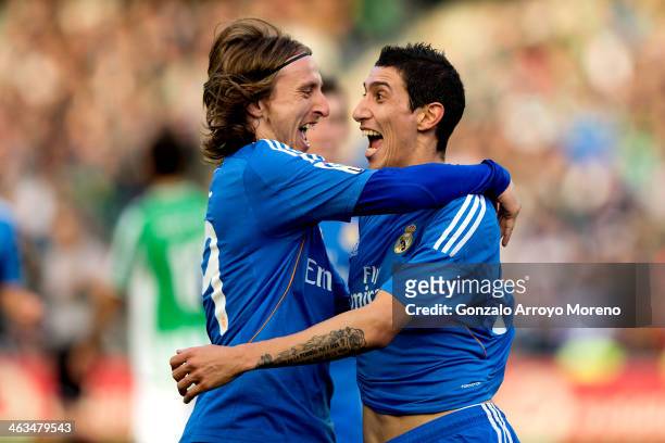 Angel Di Maria of Real Madrid CF celebrates scoring their fourth goal with teammate Luka Modric during the La Liga match between Real Betis Balompie...