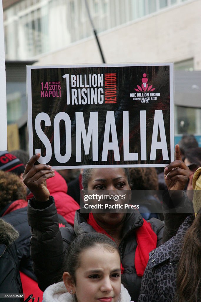 A group of one Billion Rising participants raise their hands...