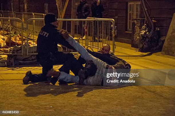 Danish policemen arrest an drunk man shortly after a shooting near a synagogue in central Copenhagen, Denmark on 15 February 2015 after one person...