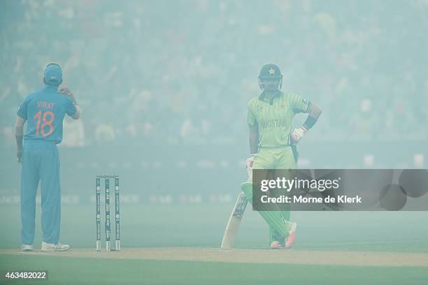 Ahmad Shahzad of Pakistan waits for smoke to clear during the 2015 ICC Cricket World Cup match between India and Pakistan at Adelaide Oval on...