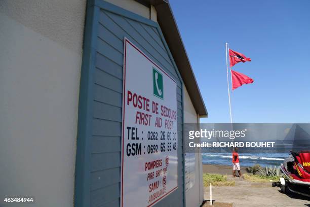Board informs with emergency phone numbers at a first aid post on a beach in Etang Sale town, on February 15 a day after a woman died after suffering...